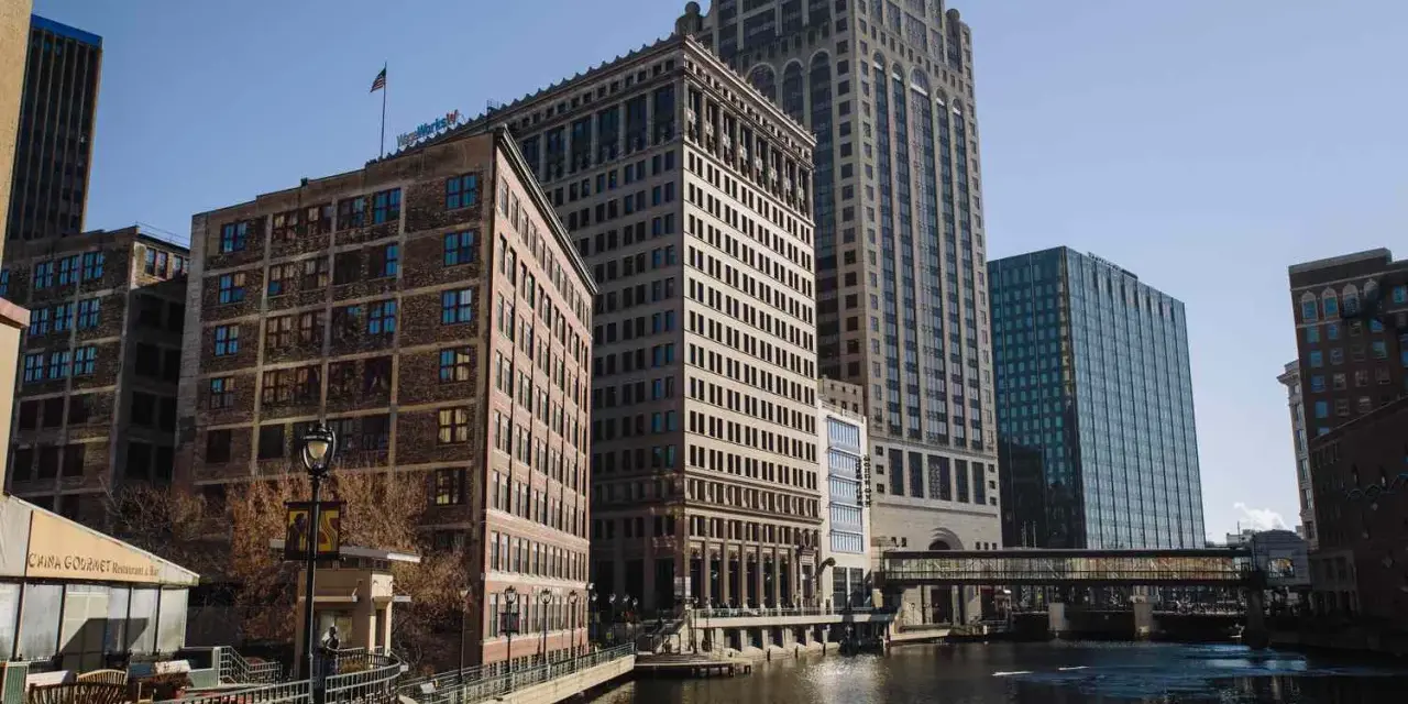 A scenic view of Milwaukee's riverfront buildings, perfect for a weekend getaway.