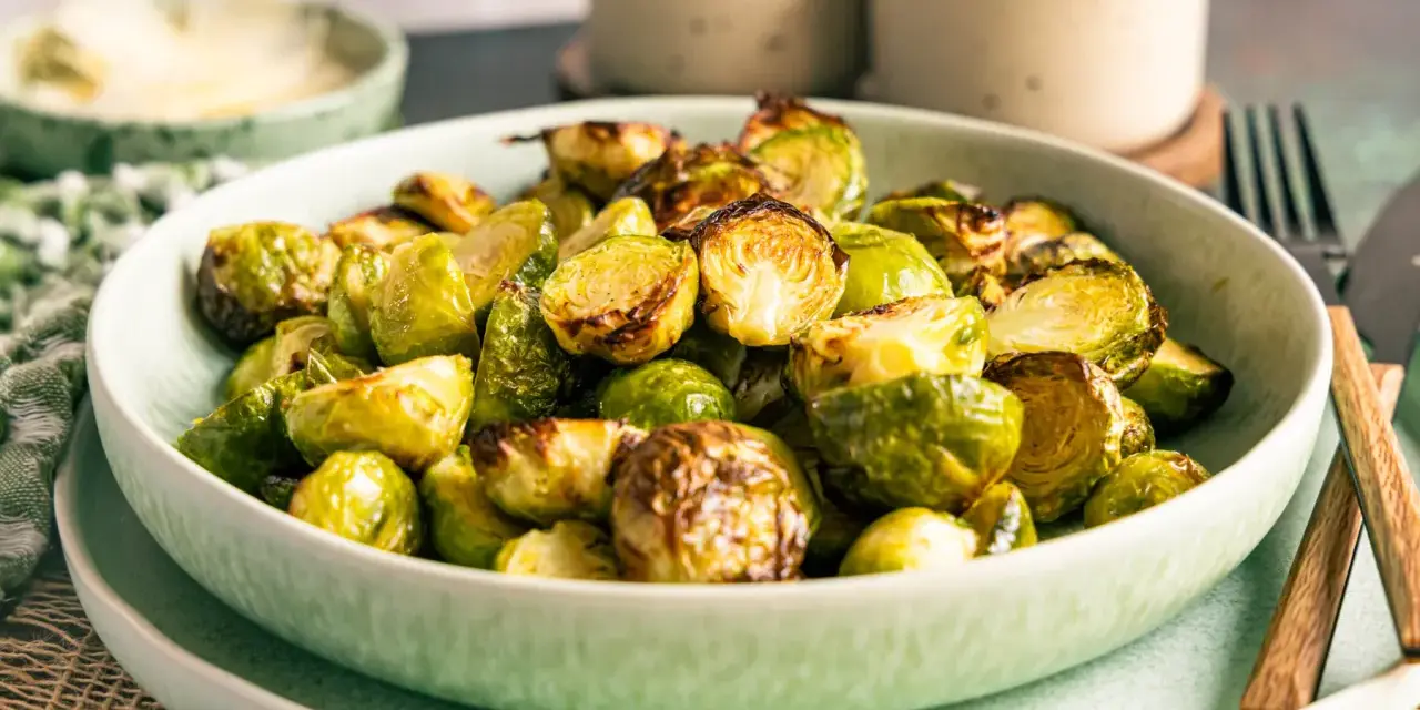 Knusprig gebratener Rosenkohl im Airfryer, goldbraun und appetitlich in einer Schüssel angerichtet.
