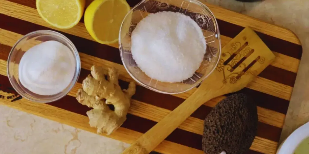 Ingredients for a homemade foot soak to remove dead skin: lemons, ginger, sugar, and a pumice stone.