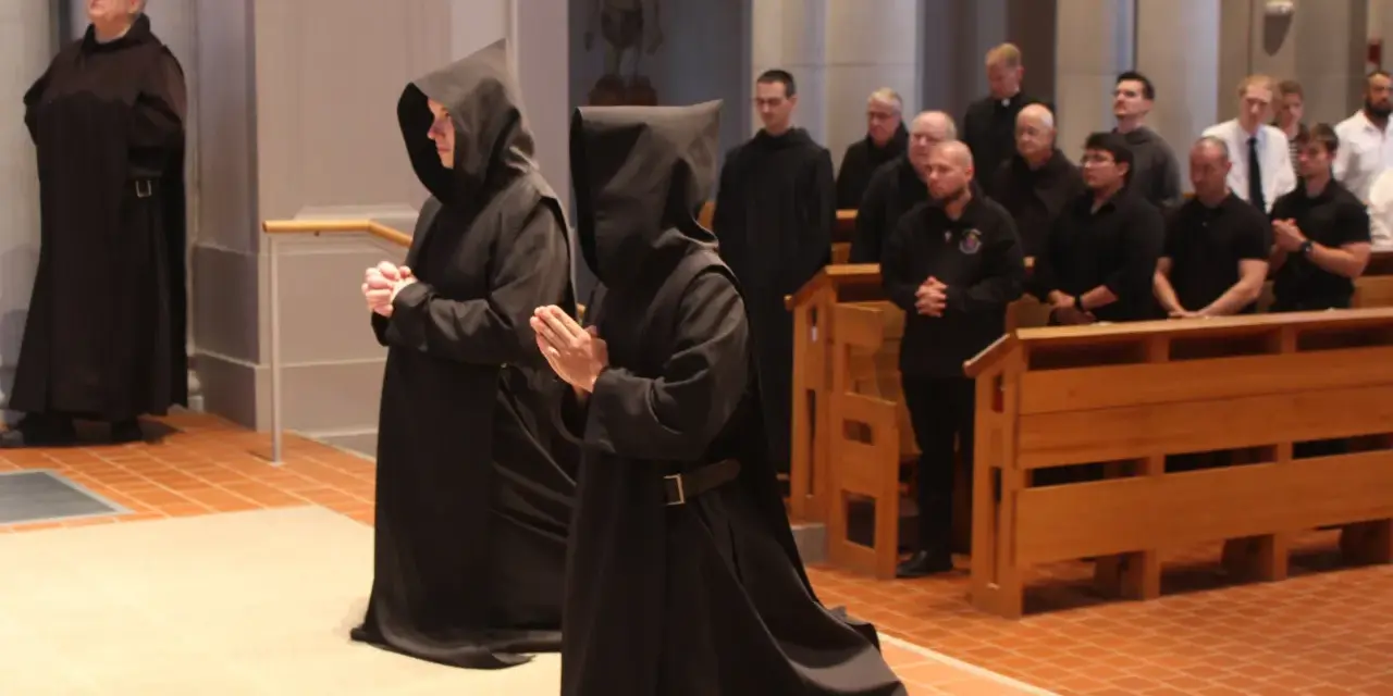 Monk characteristics are evident in the solemn robes and prayerful stances of individuals in a church setting.