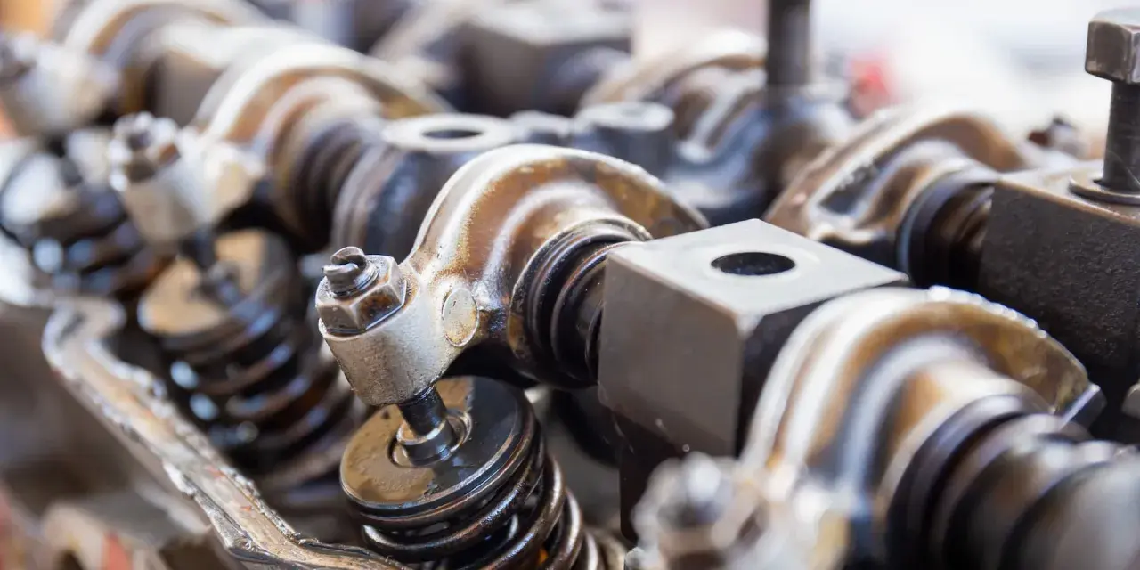 Close-up of engine valve train components, hinting at a camshaft sensor replacement.