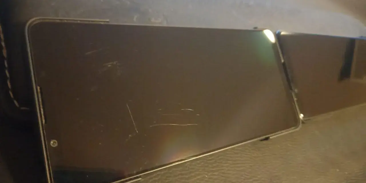 Dwa smartfony leżą obok siebie. Ekran jednego z nich, wykonany z Gorilla Glass Victus 2, nosi ślady zarysowań.