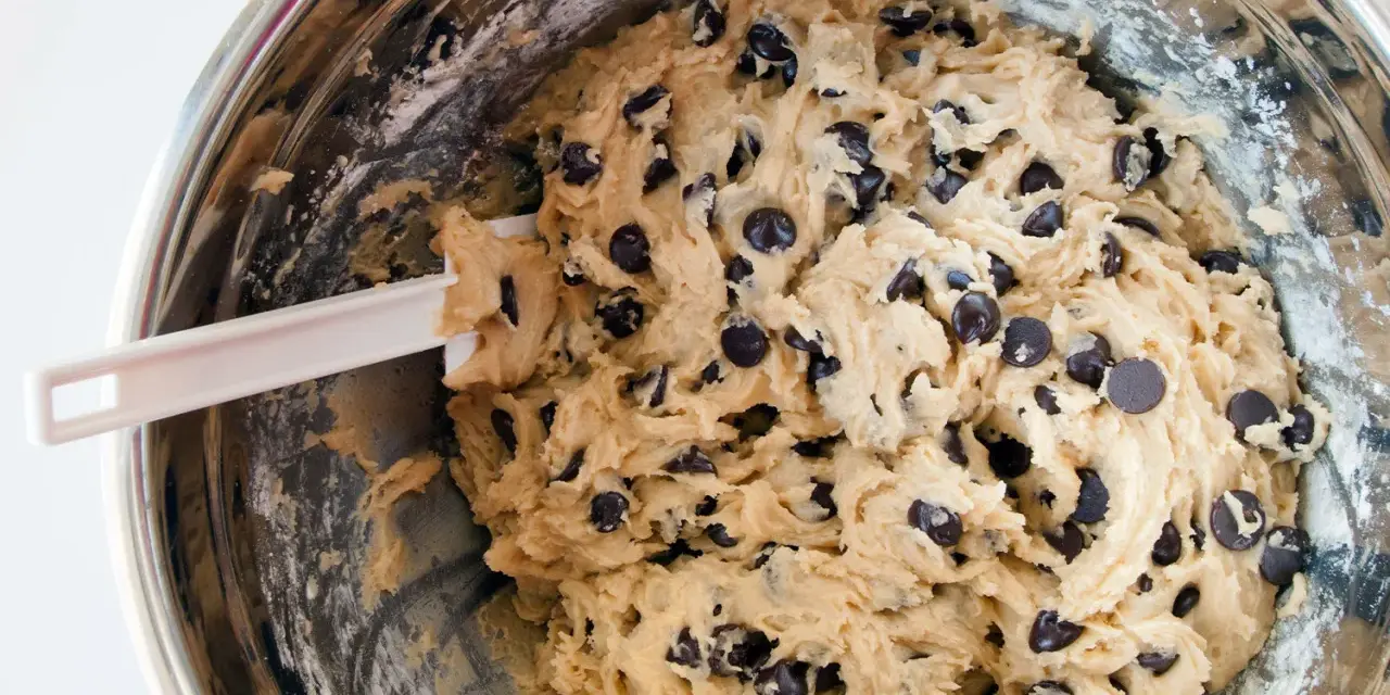 Impasto per biscotti fatti in casa con gocce di cioccolato, pronto per essere infornato.