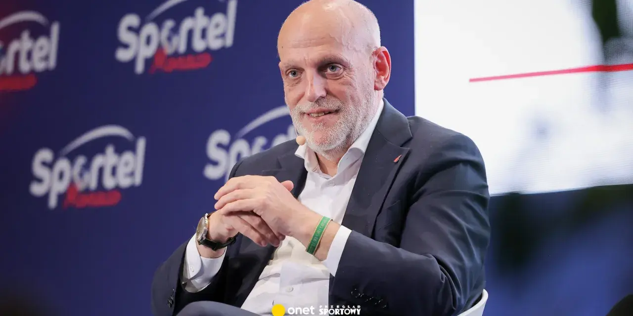 Uśmiechnięty Javier Tebas, prezes La Liga, w garniturze, na tle logo Sportel Forum.