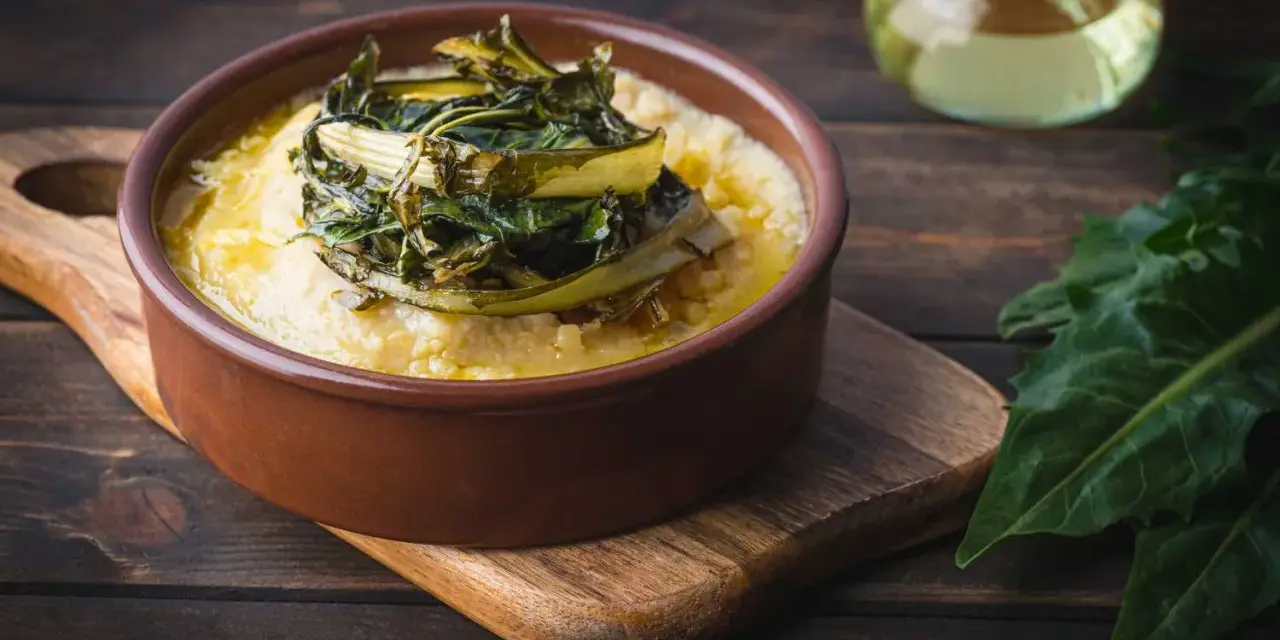 Polenta cremosa con cicoria in padella, un piatto rustico e saporito.