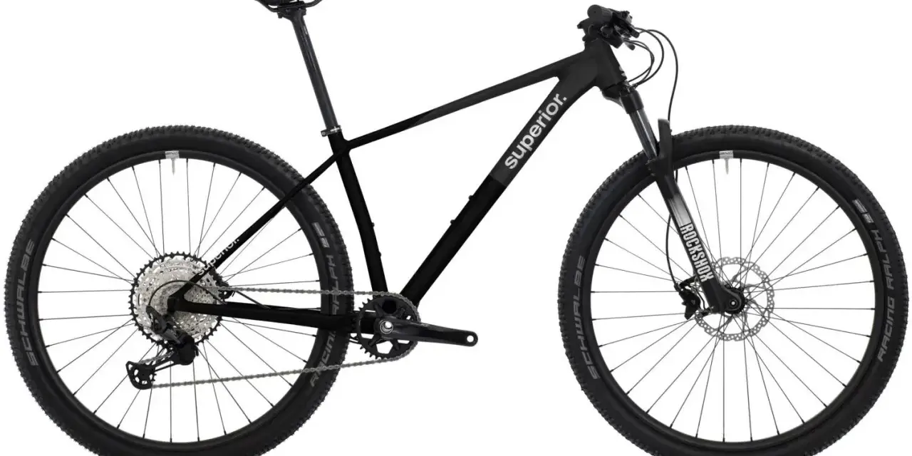 Sleek black mountain bike with "Superior." branding, ready for any road or trail. Features RockShox fork and Schwalbe tires.