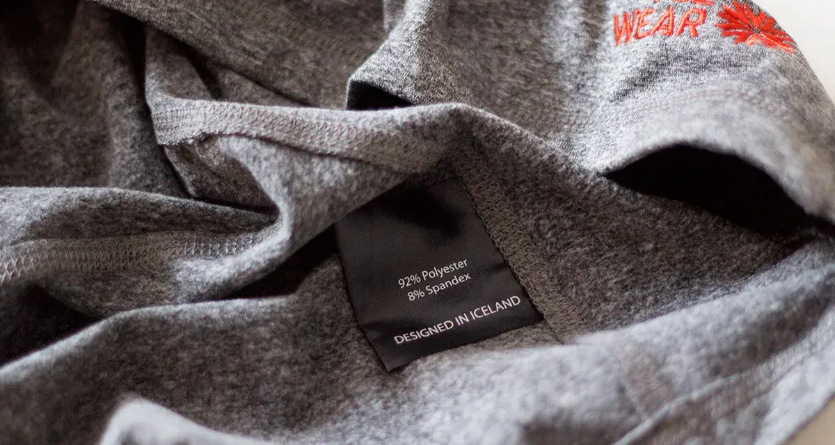 Szara koszulka z poliestru i spandexu, z haftem "ICE WEAR". Idealna na chłodne dni, zapewnia komfort i trwałość.