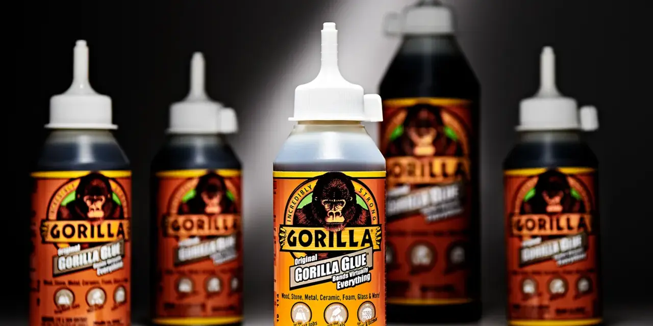 Several bottles of Gorilla Glue are displayed. The front bottle shows "how much weight can Gorilla Glue hold" is a question answered by its "Incredibly Strong" bond.