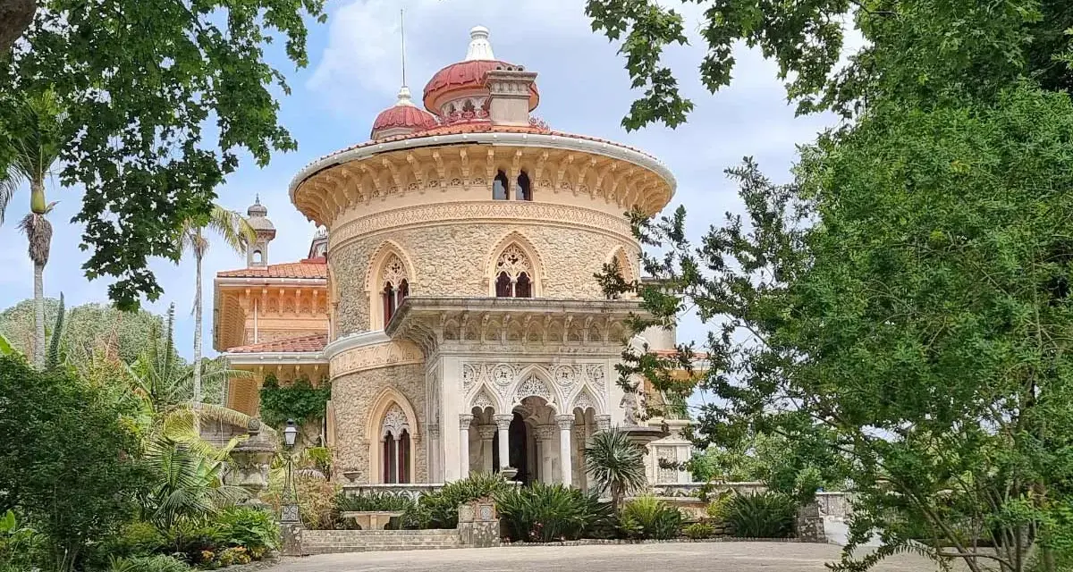 The stunning Monserrate Palace in Portugal, a fairytale castle surrounded by lush greenery and exotic plants.