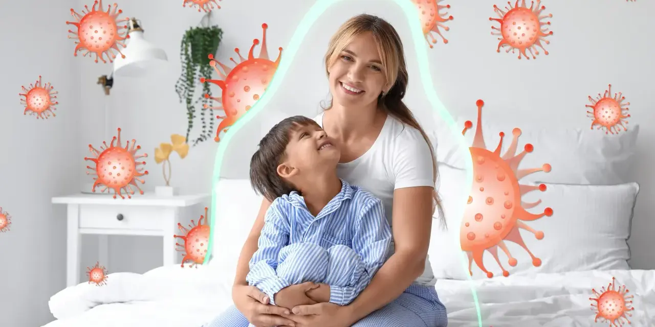 Mama tuli dziecko, które miało kaszel w nocy. Wokół nich wirusy, ale chroni je zielona bariera.