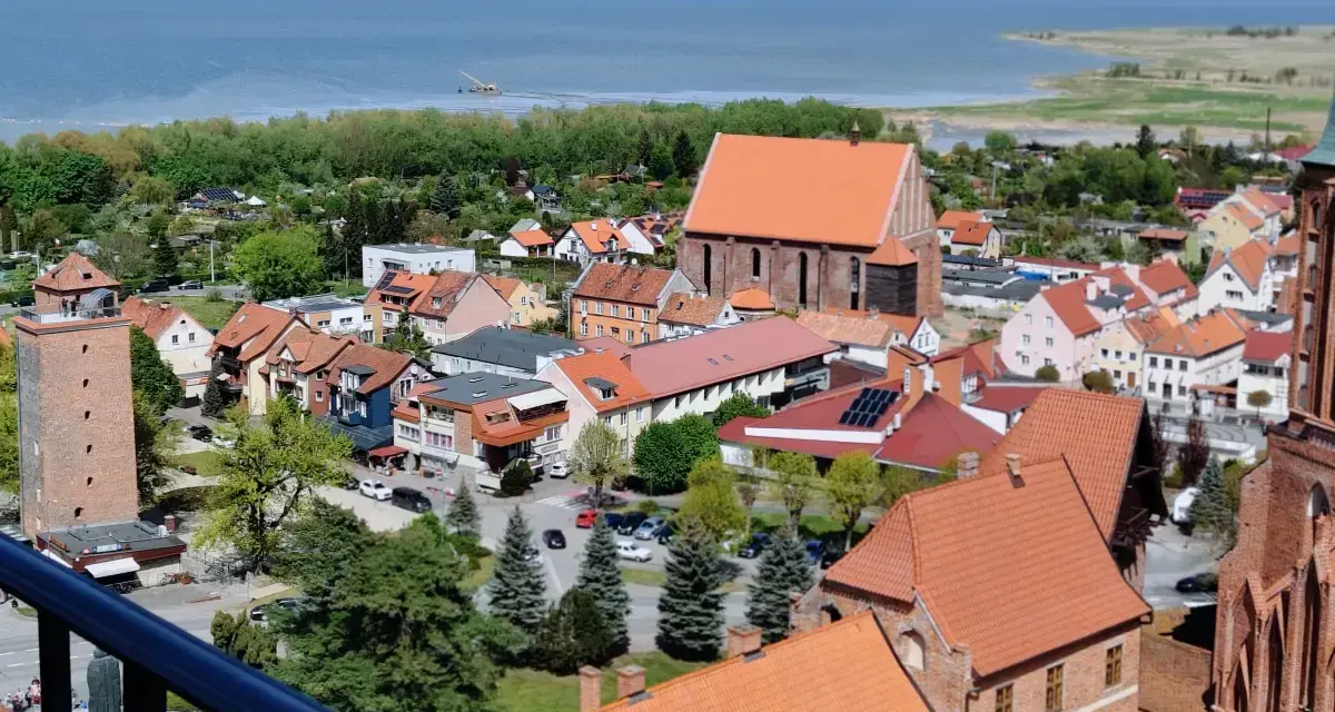 Widok na miasto z wieżą, kościołem i zatoką. Tolkmicko atrakcje zachęcają do zwiedzania urokliwego miasteczka nad Zalewem Wiślanym.