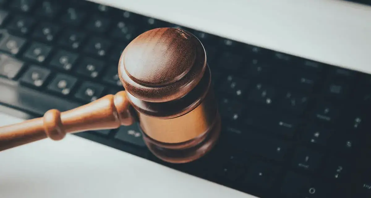 Marteau de juge sur un clavier d'ordinateur, symbolisant les revenus pris en compte pour pension alimentaire et la justice numérique.