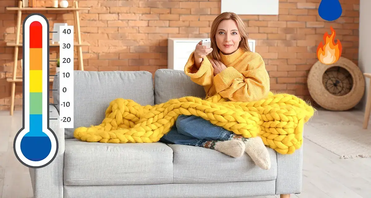 Donna sul divano con coperta gialla, termometro e icone di acqua e fuoco. Soluzione per deumidificare e riscaldare contemporaneamente.