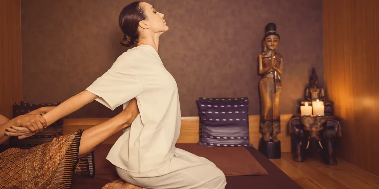 A woman receives a traditional Thai massage, a practice with a rich history rooted in ancient healing traditions.