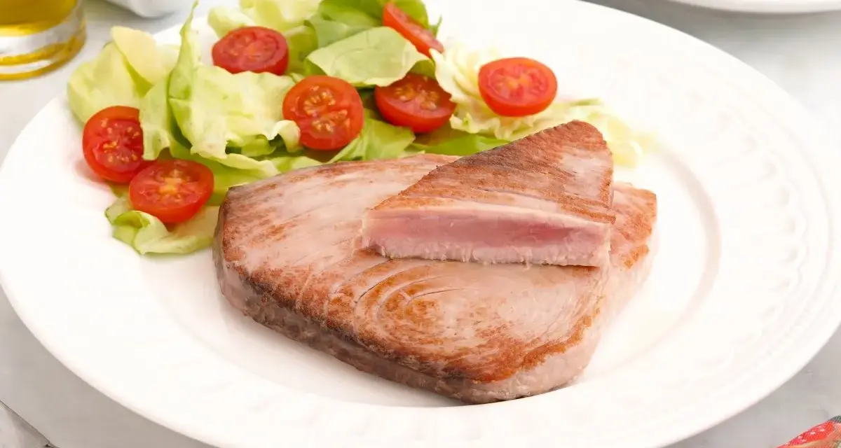 Delicioso atún a la plancha con ensalada fresca de lechuga y tomates cherry. Un plato ligero y saludable.