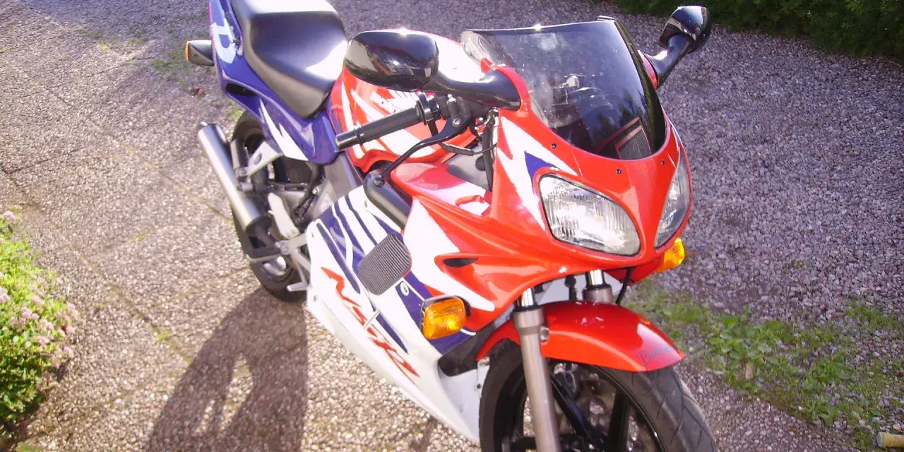 Czerwono-biało-niebieski motocykl Honda NSR 125. Poznaj jego dane techniczne i możliwości.