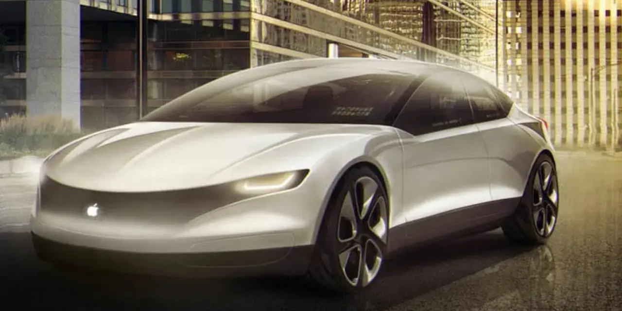 Futurystyczny, biały apple car z podświetlanym logo jabłka, zaparkowany przed nowoczesnymi budynkami w nocy.
