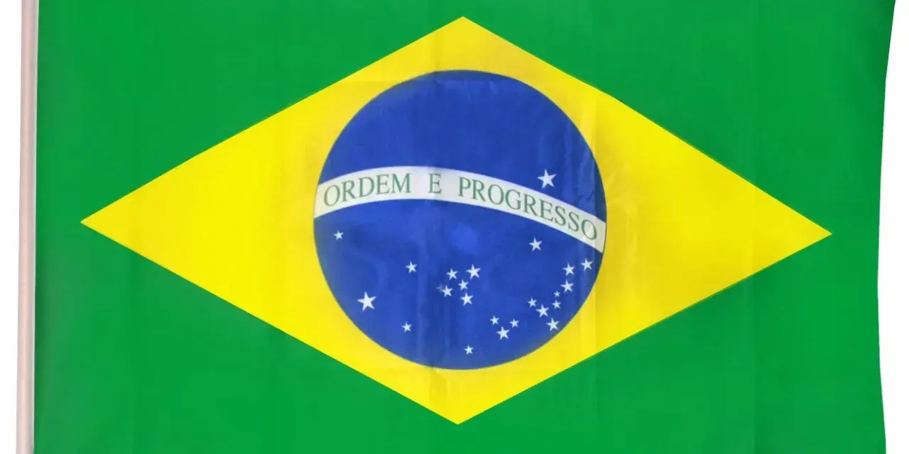 Flaga Brazylii z napisem "Ordem e Progresso" na niebieskiej kuli, symbolizująca marzenia o postępie i rozwoju.