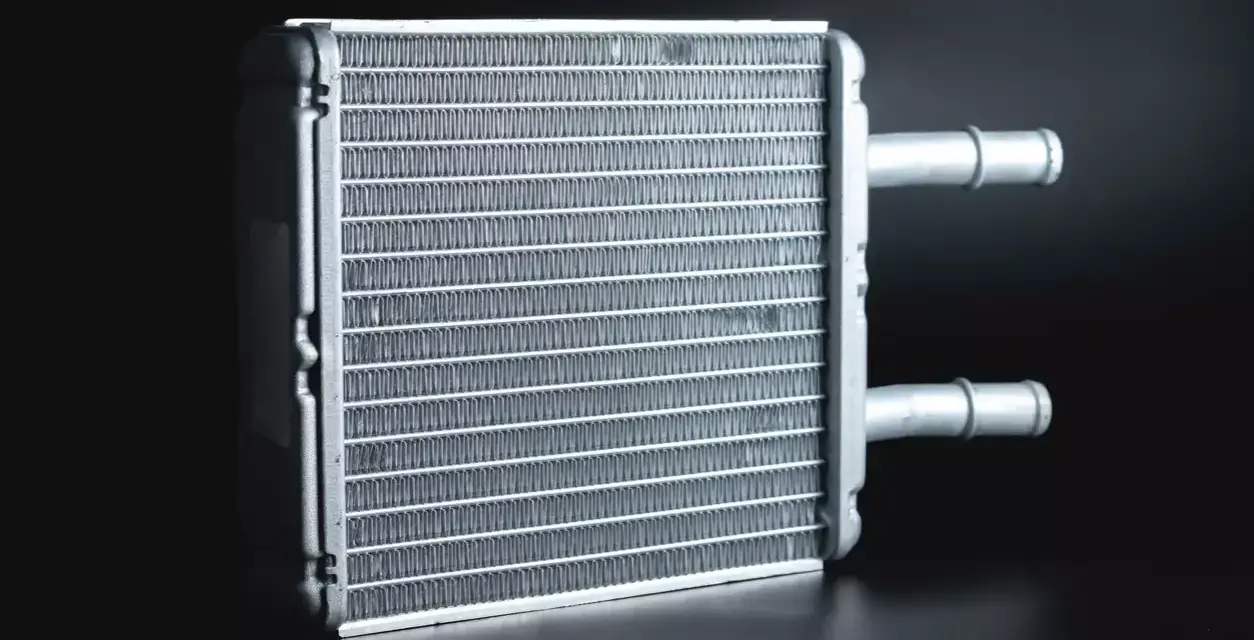 A new heater core, essential for a heater core replacement, sits ready for installation. Its fins are clean and ready to warm your car.