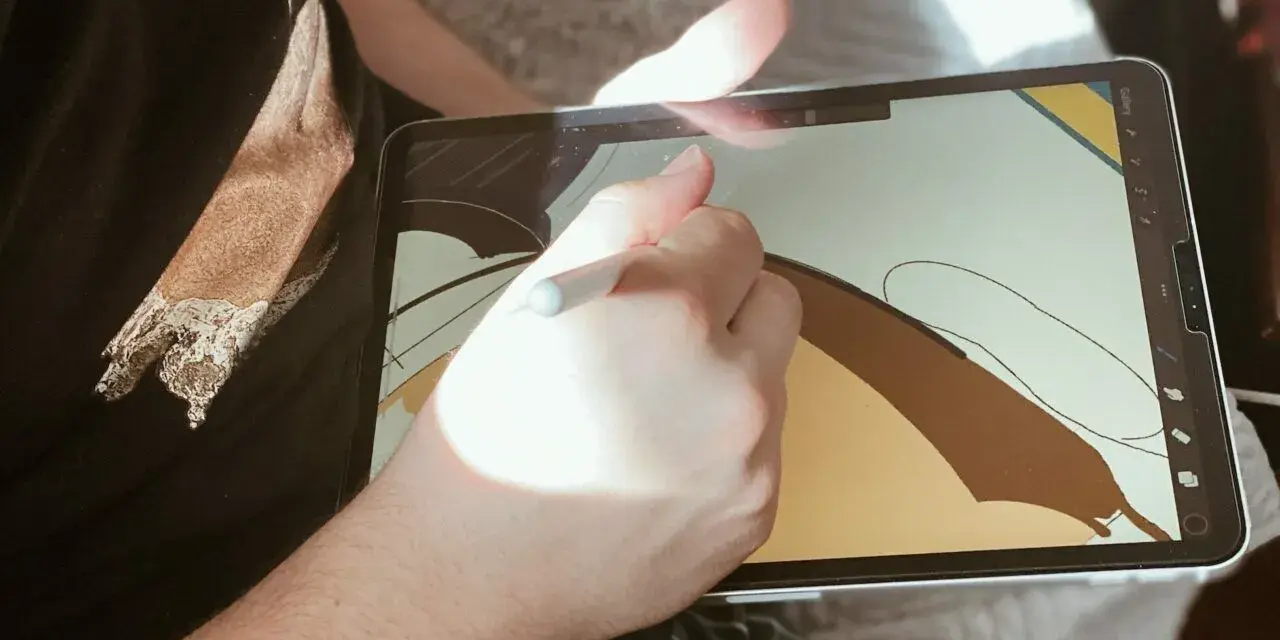 Osoba rysuje na ekranie iPad'a, używając rysika. To cyfrowy tablet graficzny, idealny do tworzenia sztuki.