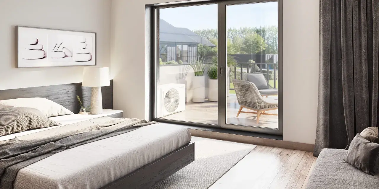 Unidad exterior de aire acondicionado visible a través de la puerta corredera, con una cama y arte de pared en la habitación.
