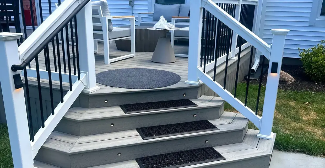A beautifully lit deck staircase, showcasing how to build deck stairs with integrated lighting and non-slip mats.