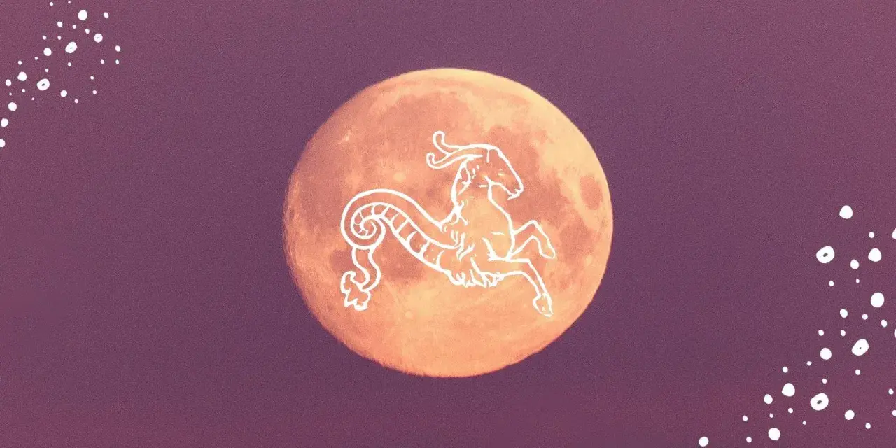 Pomarańczowy księżyc w Koziorożcu, ozdobiony białym symbolem zodiaku.