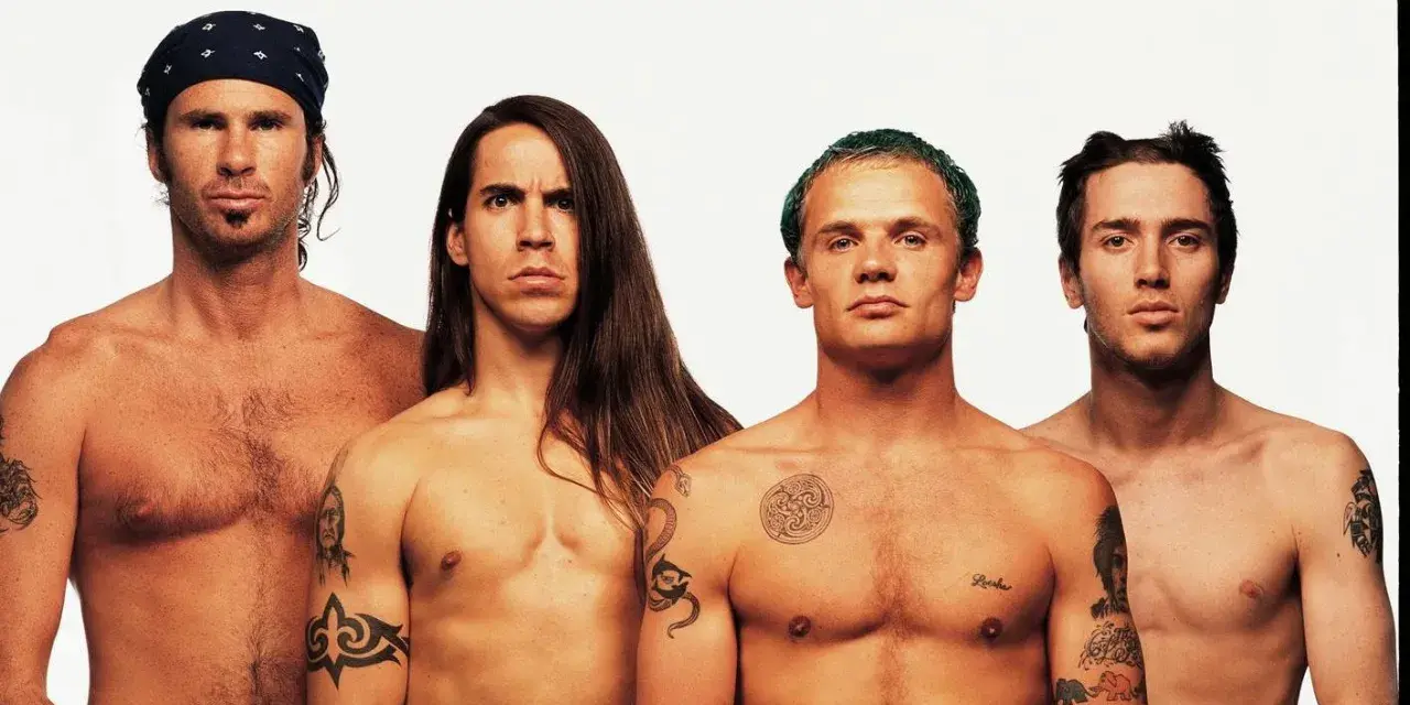 Les membres des Red Hot Chili Peppers, torse nu, posent pour une photo. L'âge ne semble pas avoir d'emprise sur leur énergie.