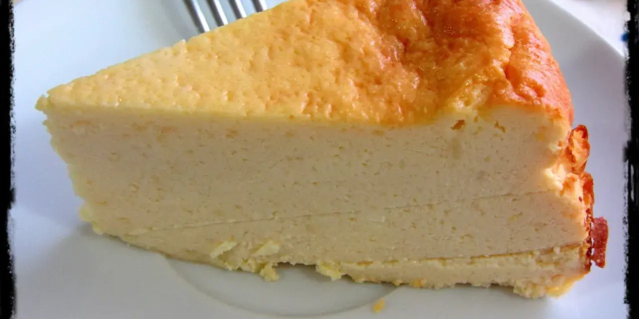 Una rebanada de tarta de queso light, con su dorada superficie y cremosa textura, lista para disfrutar.