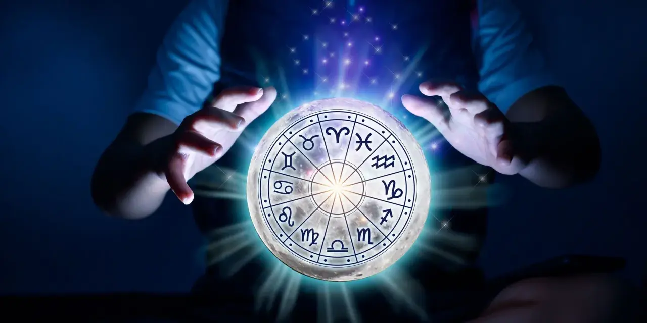 Dłonie unoszą księżyc z tarczą zodiaku, gdzie znaki zodiaku i żywioły splatają się w mistycznym świetle.