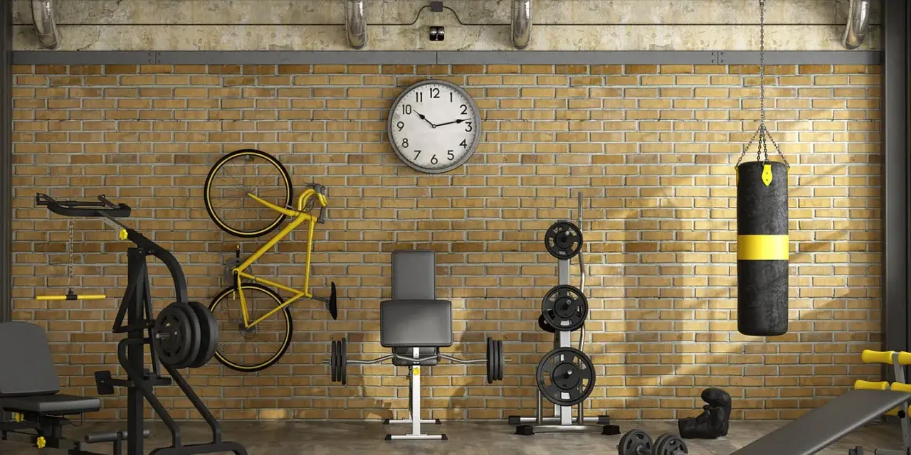 Ett välutrustat gym i garaget med vikter, boxningssäck, cykel och träningsbänk.