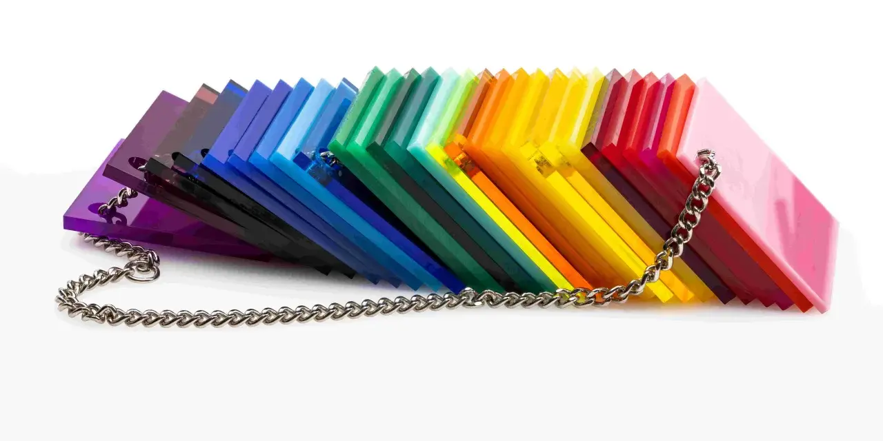 A rainbow fan of acrylic sheets, showcasing varying shades and the material's density, is held together by a silver chain.