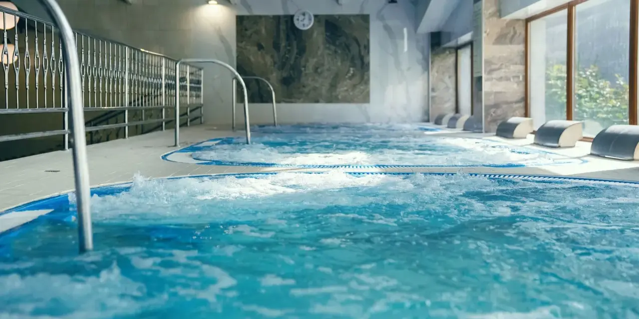 Relaks w hotelu z basenem w Białymstoku. Bąbelki unoszą się w wodzie jacuzzi, zapraszając do odpoczynku.
