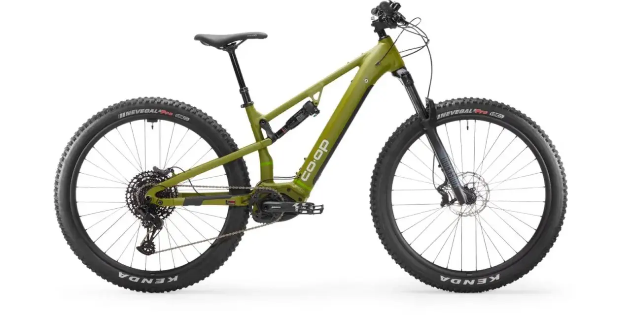 A green Co-op electric mountain bike, ready for a REI bike tune-up, with full suspension and knobby tires.