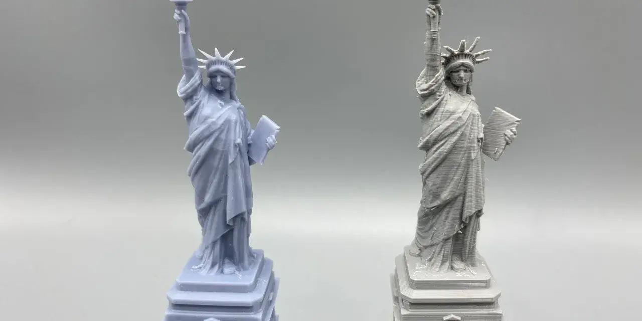 Two Statue of Liberty models: one smooth, likely resin vs. filament 3d printer with visible layer lines.