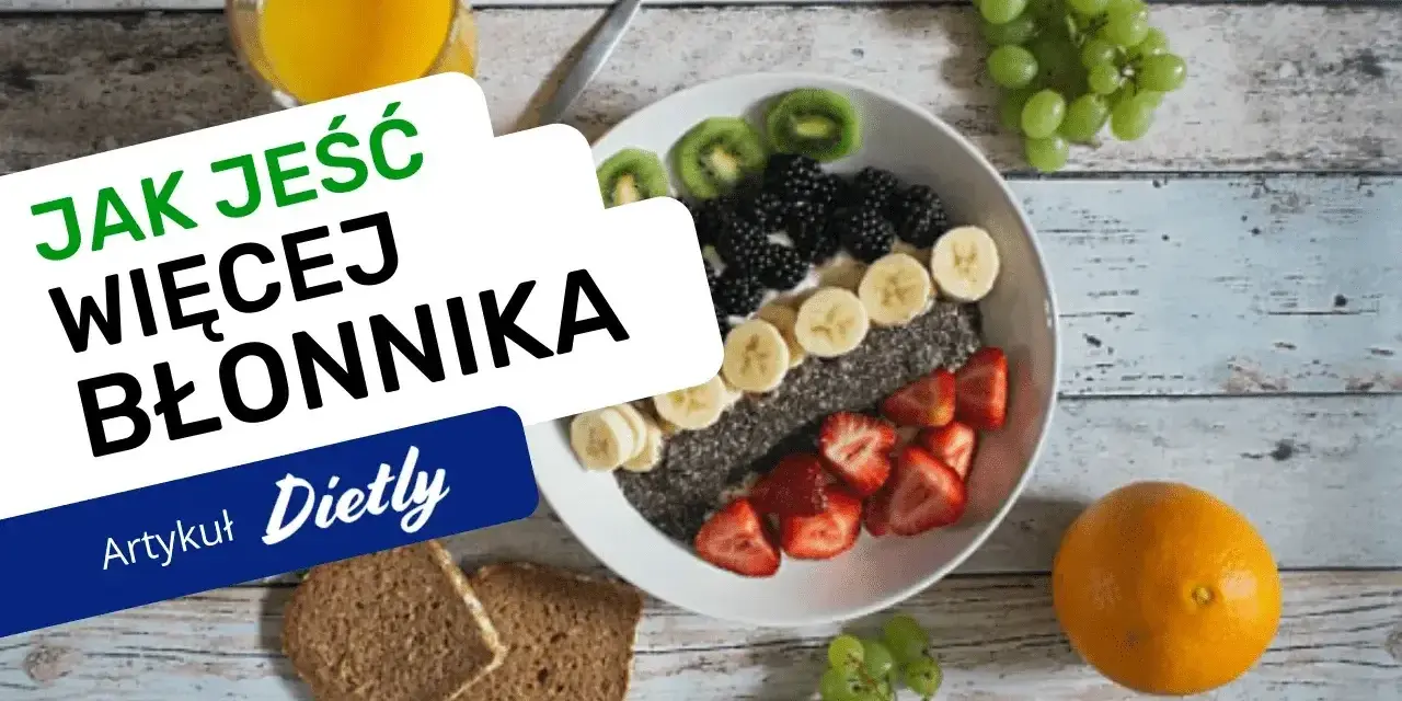 Pyszna owsianka z owocami i nasionami chia, idealna na śniadanie, które ma duzo blonnika. Obok szklanka soku i kromki chleba.
