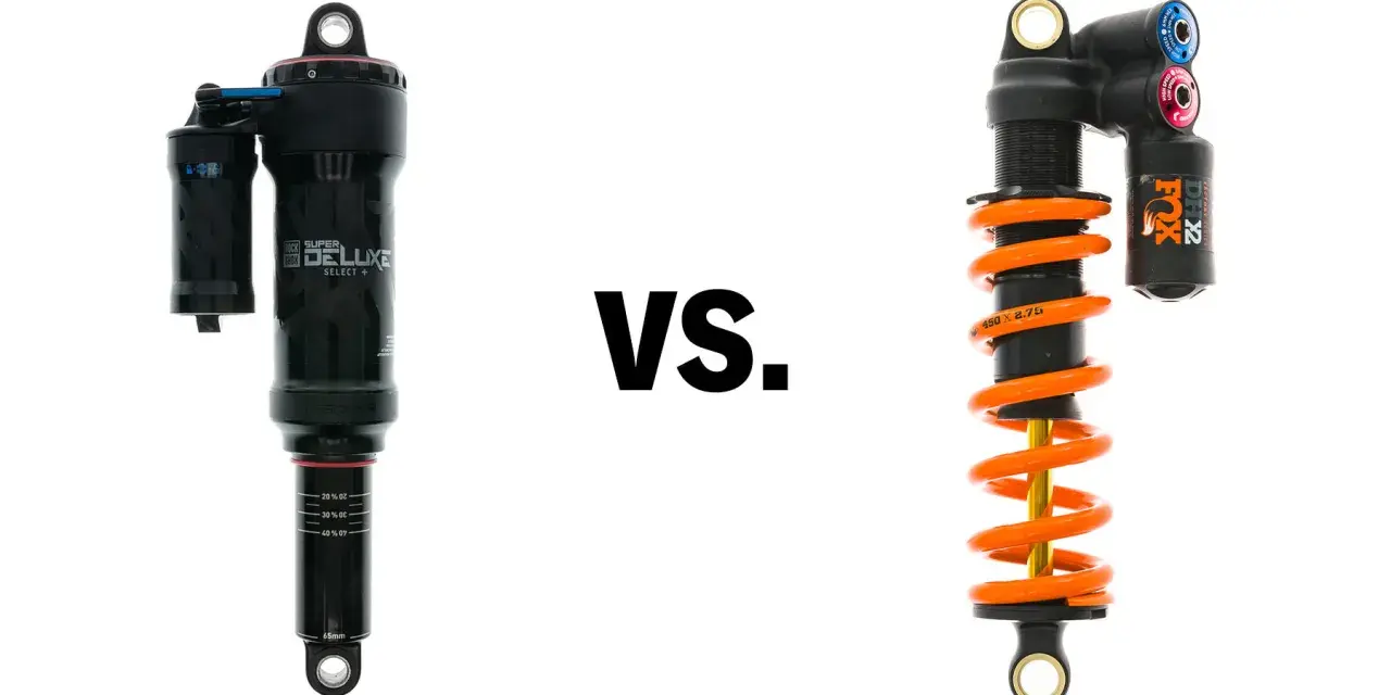 A black air shock and an orange coil shock are shown side-by-side, illustrating the coil vs air shock debate for mountain bikes.