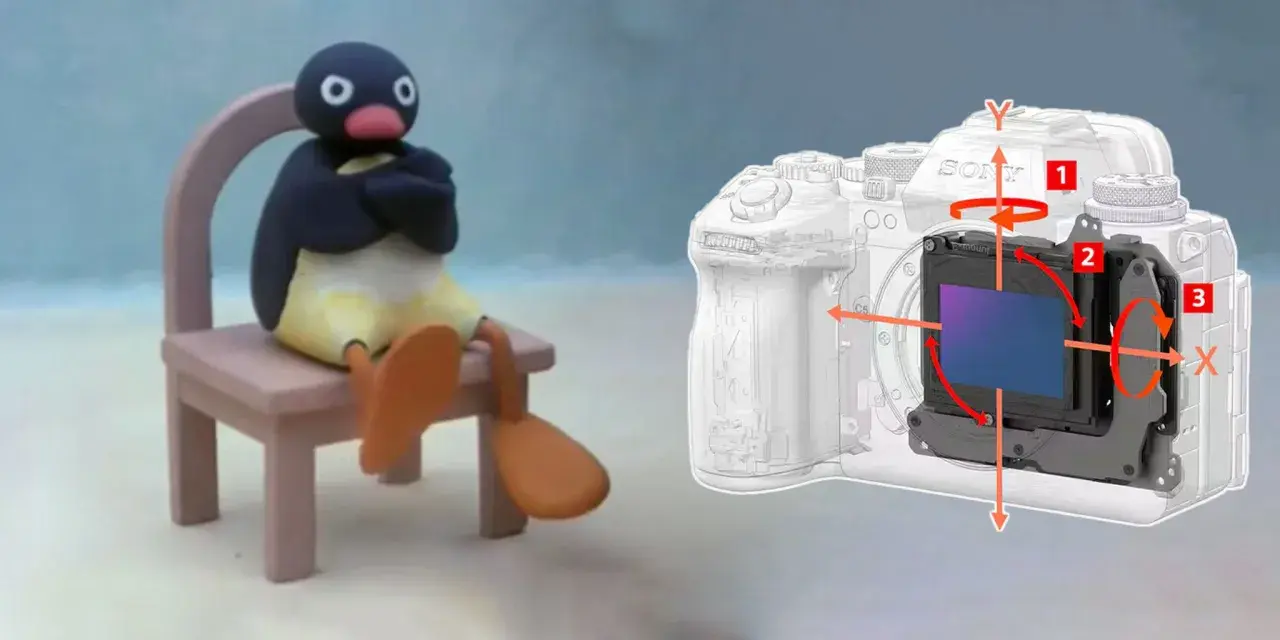 Pingu siedzi na krześle obok aparatu z widocznym mechanizmem optycznej stabilizacji obrazu, który kompensuje ruchy.
