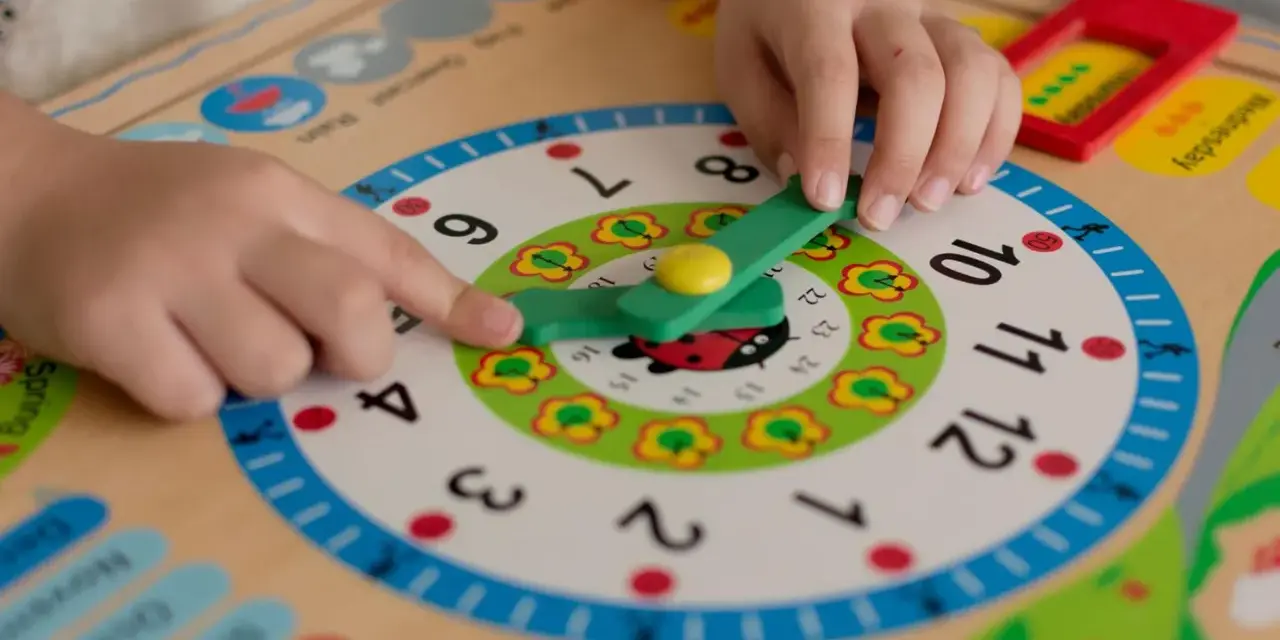 Kind lernt Uhrzeit: Zeiger auf 9, wie bringe ich meinem Kind die Uhr bei? Bunte Lernuhr mit Marienkäfer.