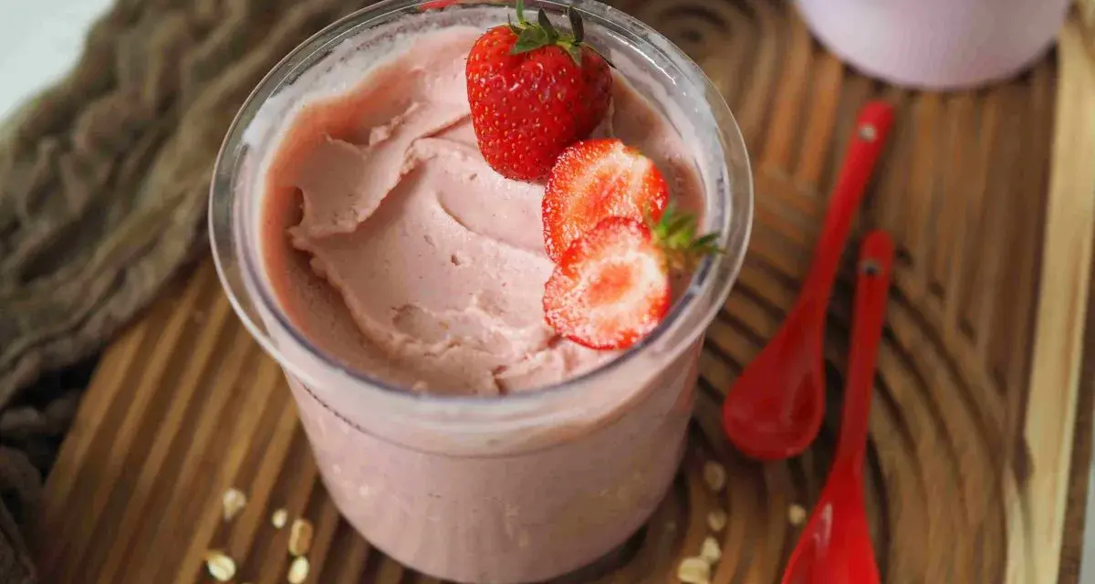 Cremiges Kefir Eis mit frischen Erdbeeren garniert, bereit zum Genießen.