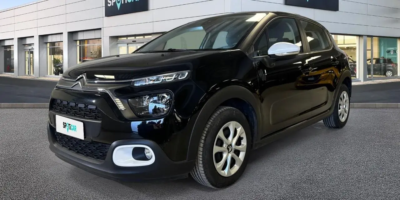 Citroën C3 nera parcheggiata davanti a uno showroom Spoticar. Controlla la pressione pneumatici per un viaggio sicuro.