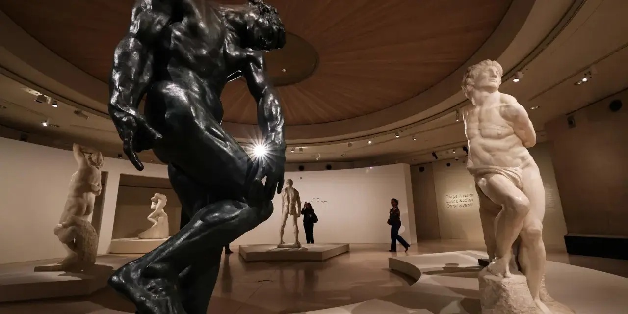 Musée d'art présentant des sculptures de sculpteurs célèbres, dont une grande statue en bronze et une statue en marbre.