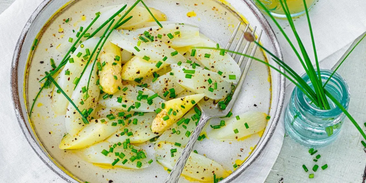 Spargel mal anders: zarte weiße Spargelstücke in einer cremigen Sauce, garniert mit Schnittlauch und Pfeffer. Ein leichter Genuss.