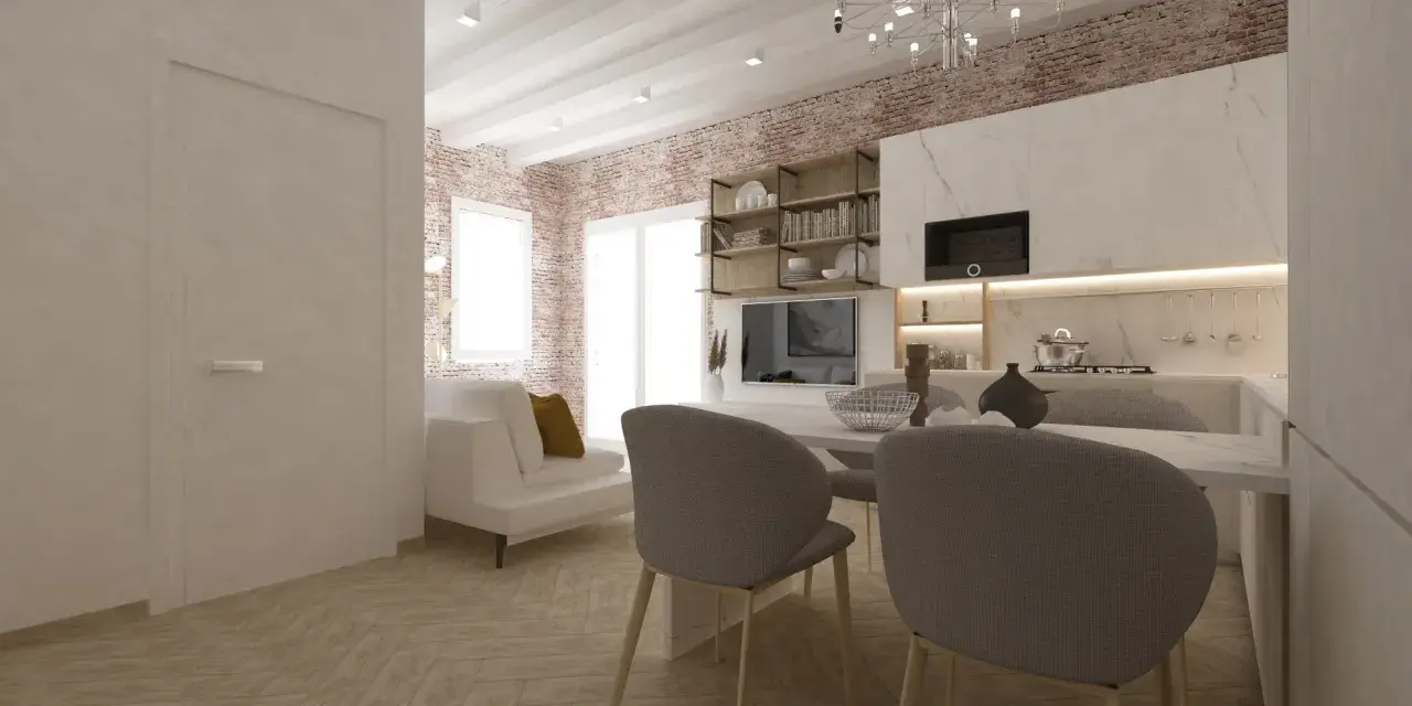 Arredare monolocale con stile: divano bianco, cucina moderna, mattoni a vista e tavolo da pranzo.