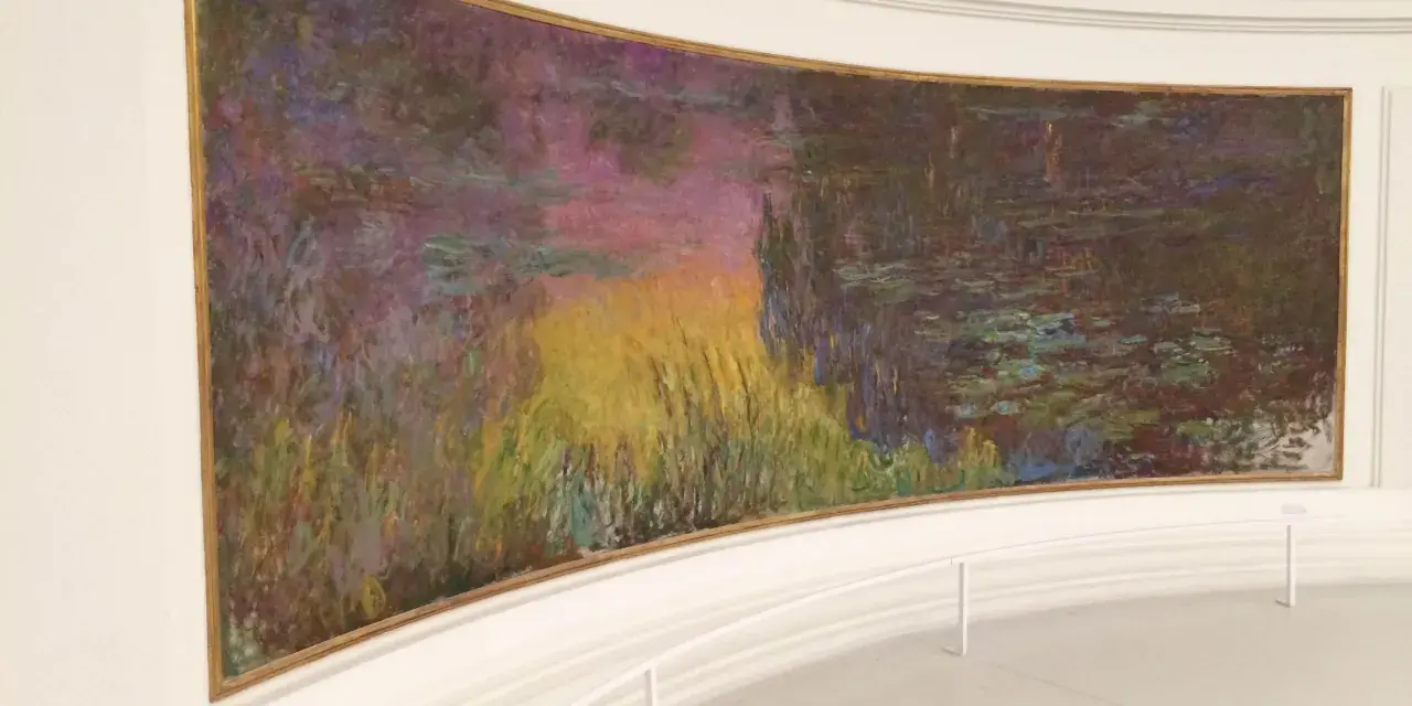 Un estanque de nenúfares con reflejos vibrantes de atardecer, una obra maestra impresionista en el **museo de la Orangerie**.
