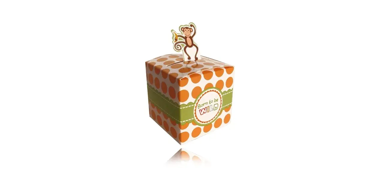 A white gift box with orange polka dots and a green ribbon, topped with a monkey cutout.