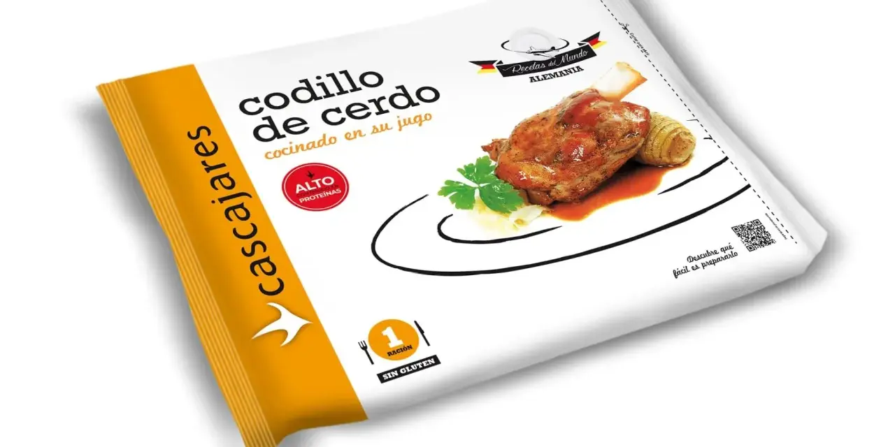 Paquete de codillo de cerdo cocinado en su jugo, con guarnición de patatas y perejil.