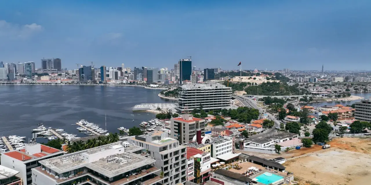 Luanda, stolica Angoli, z nowoczesnymi wieżowcami, mariną pełną jachtów i historycznym fortem na wzgórzu.