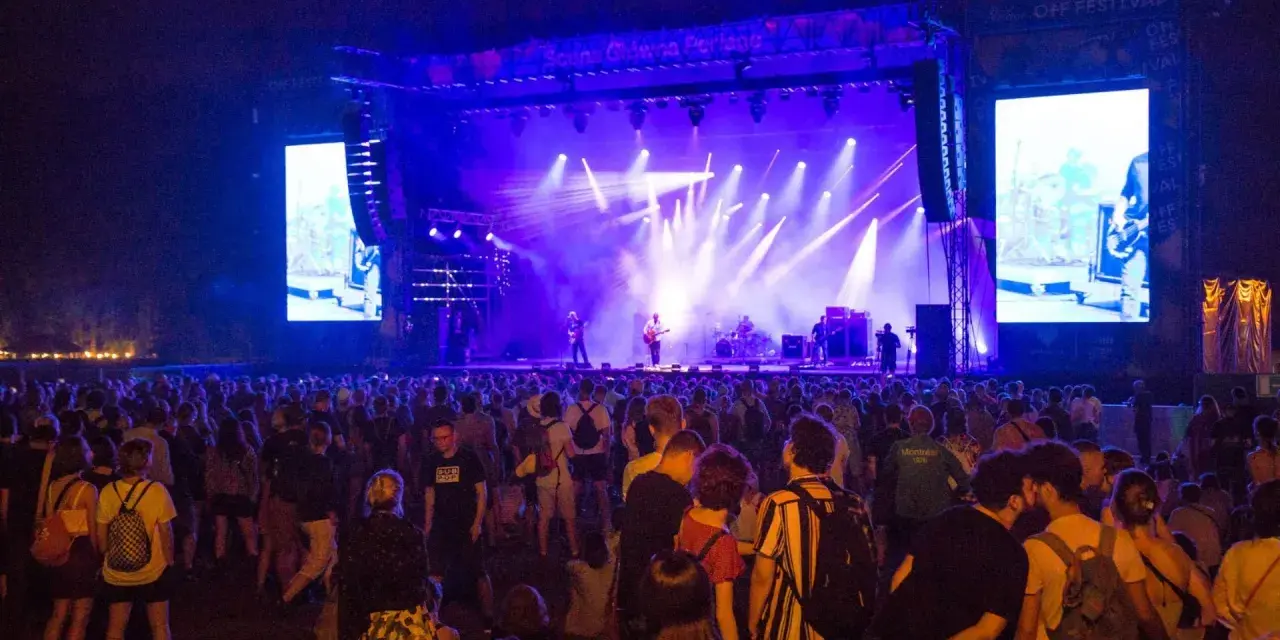Tłum ludzi na koncercie OFF Festival 2026. Na scenie zespół w świetle reflektorów, a obok wielki ekran z transmisją.