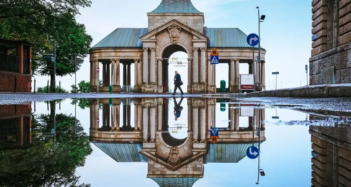 Odbicie zabytkowej budowli w kałuży po deszczu. Warto zobaczyć to miejsce w Szczecinie, szczególnie po opadach.
